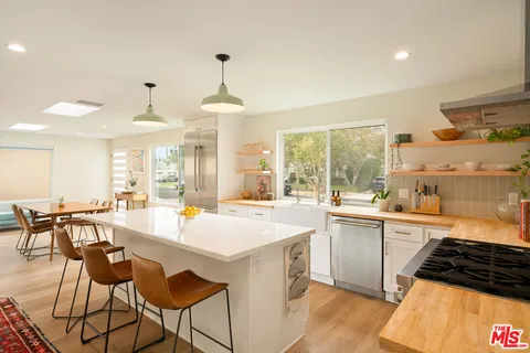 a large kitchen with a table and chairs