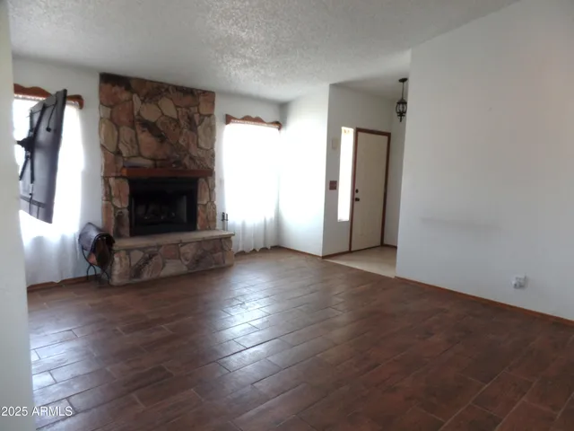 a living room with a fireplace and a flat screen tv