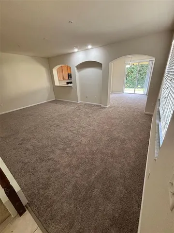 a view of an empty room and a window