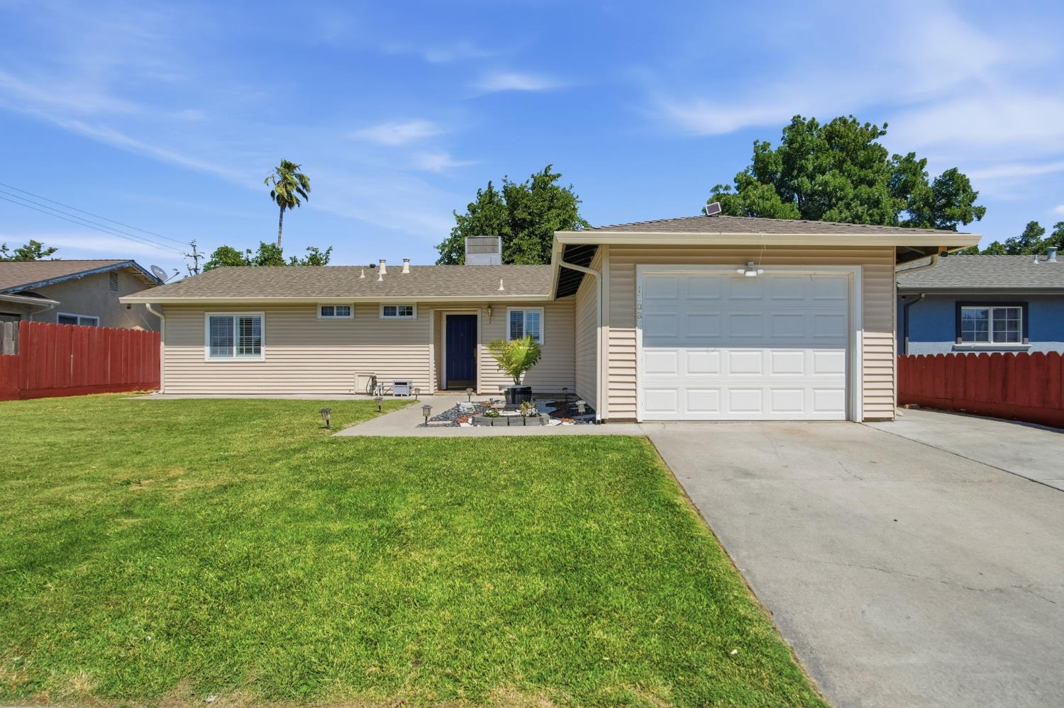 1308 Basil Court Newman, CA 95360 - Photo 2 of 20 a front view of a house with a yard and garage