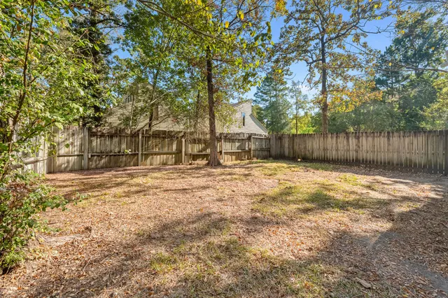 a backyard of a house with large trees