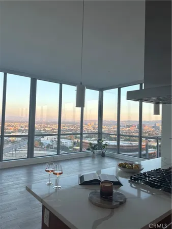 a living room with furniture and large windows