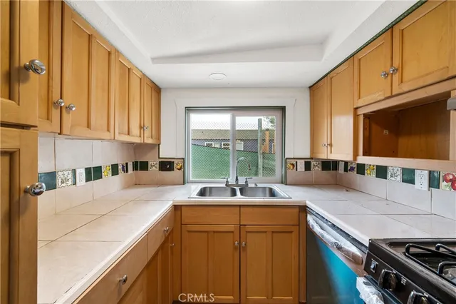 a kitchen with stainless steel appliances granite countertop a sink a stove and a microwave