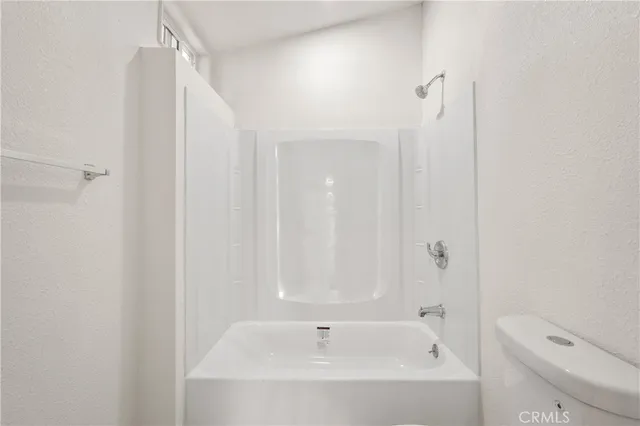 a bathroom with a bathtub and a toilet