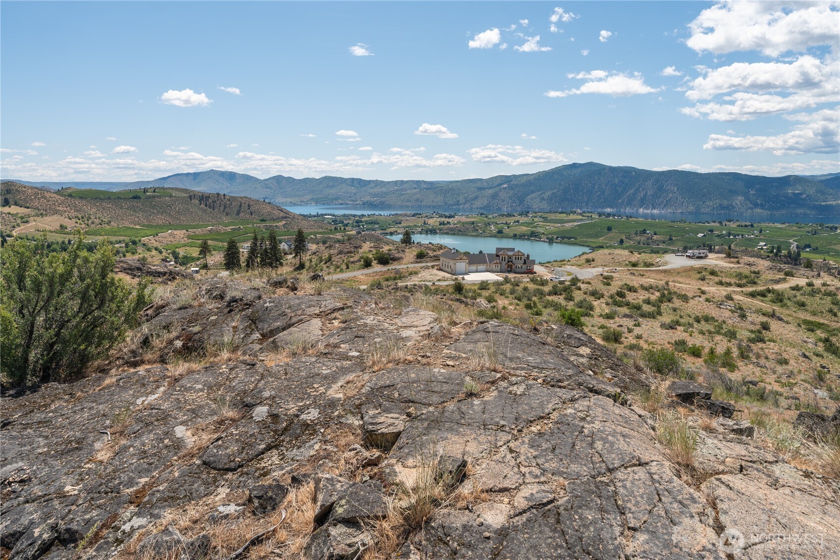 661 Glory View Lane, Unit 2 Manson, WA 98831 - Photo 14 of 19 a view of a lake with mountains in the background