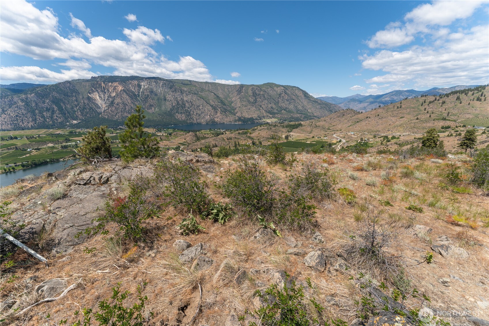 661 Glory View Lane, Unit 2 Manson, WA 98831 - Photo 16 of 19 a view of a bunch of mountains in middle of green field