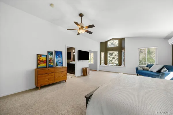 a bedroom with a bed couch and window