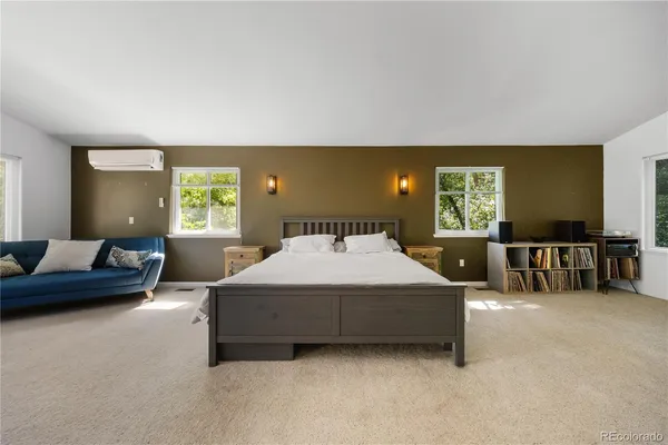 a spacious bedroom with a bed and couch