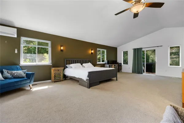 a bedroom with a bed couch and window