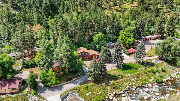 an aerial view of a house with a yard and garden