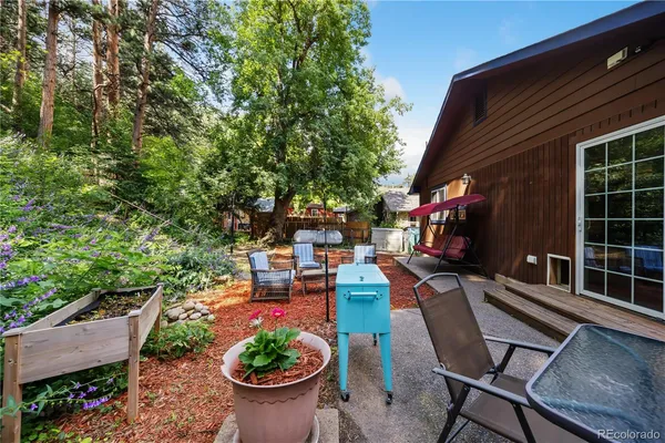 a view of backyard with outdoor seating and plants