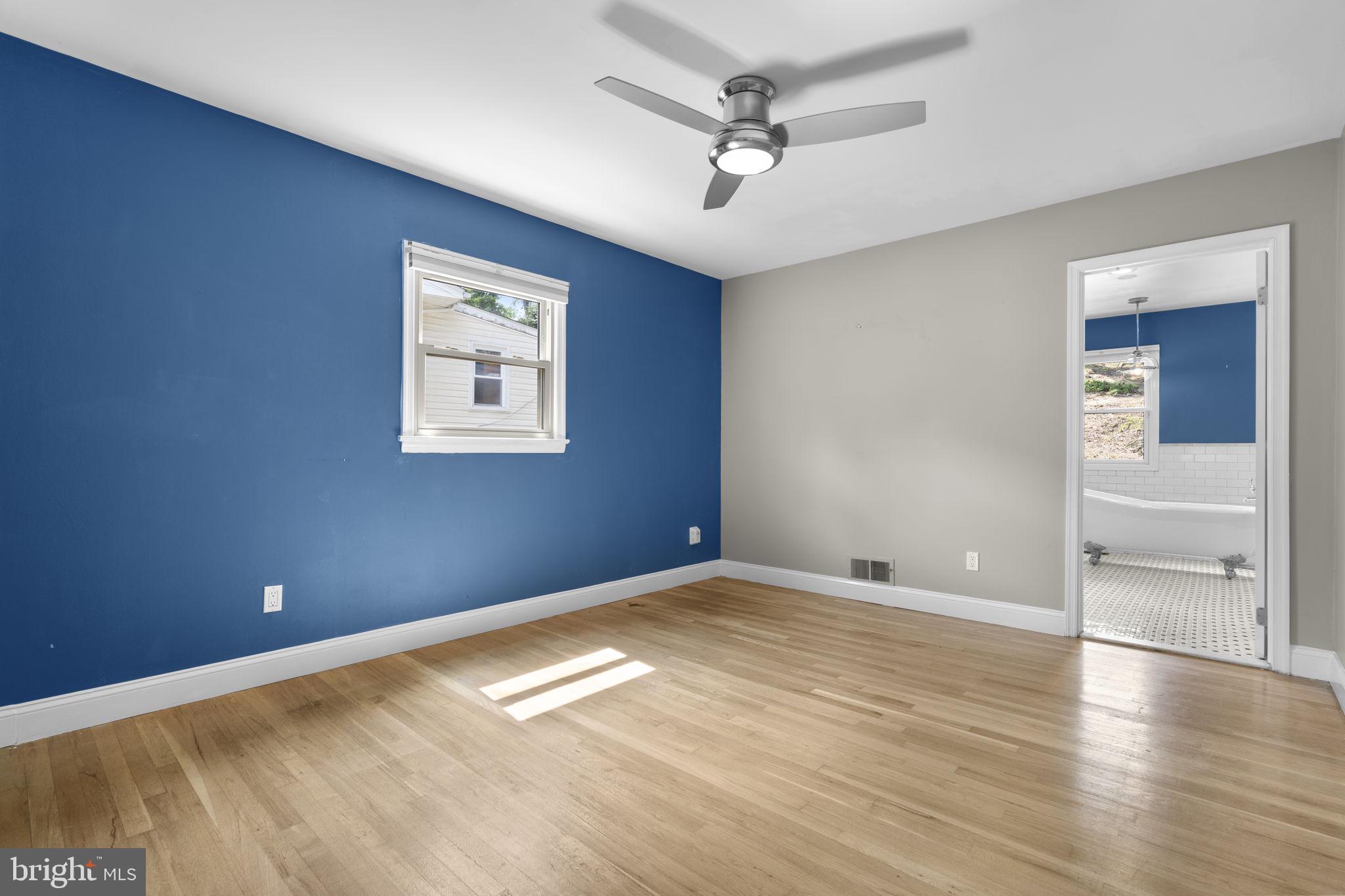 822 Loxford Terrace Silver Spring, MD 20901 - Photo 32 of 61 wooden floor in an empty room with a window
