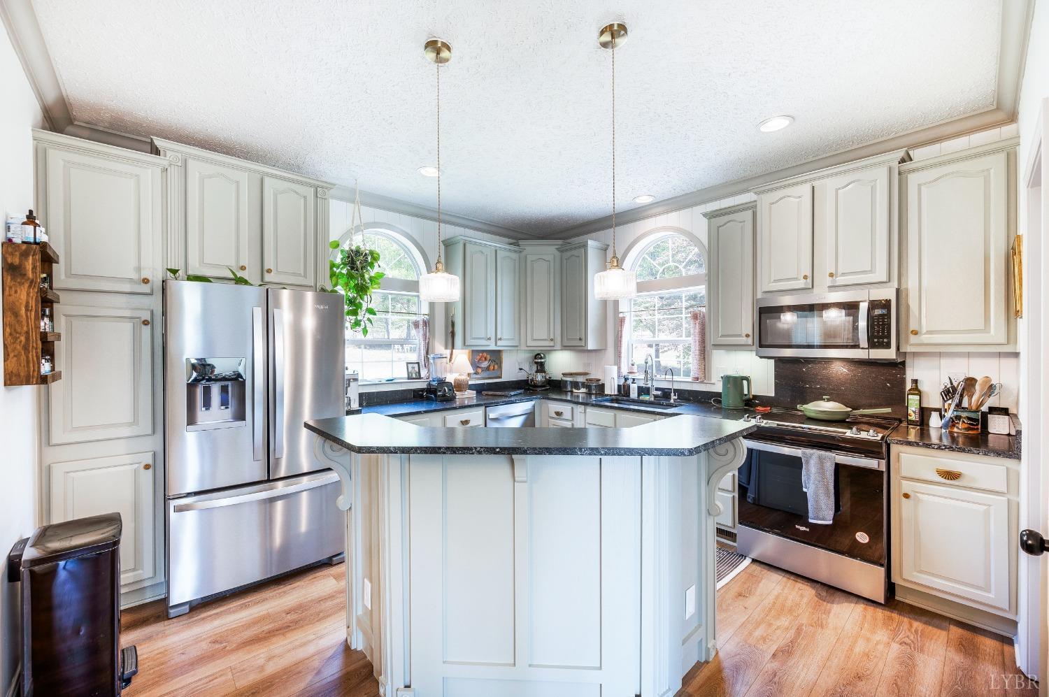 1105 East Perch Road Monroe, VA 24574 - Photo 10 of 60 a kitchen with stainless steel appliances granite countertop a sink a stove a refrigerator cabinets and wooden floor