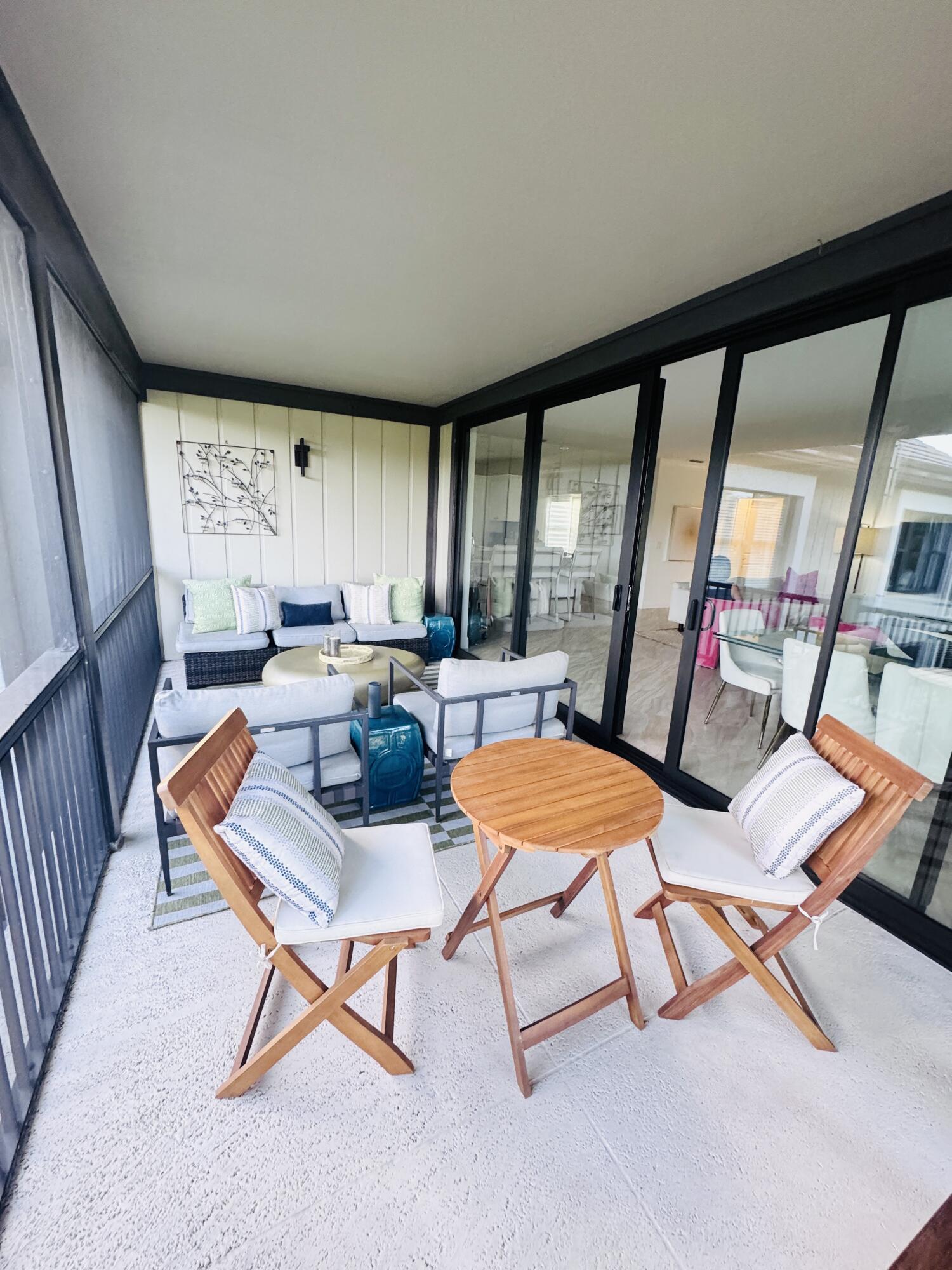 13254 Polo Club Road, Unit C204 Wellington, FL 33414 - Photo 29 of 29 a outdoor space with a large window and furniture