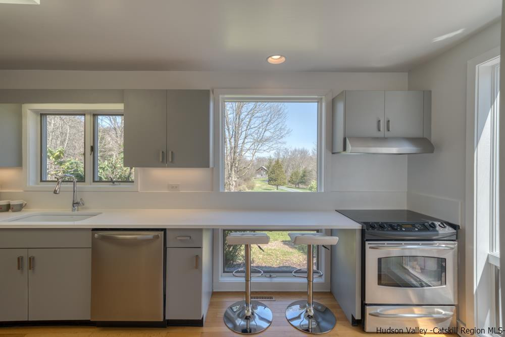 373 Red Top Road Lloyd, NY 12528 - Photo 9 of 32 a kitchen with stainless steel appliances granite countertop a stove a sink and a microwave
