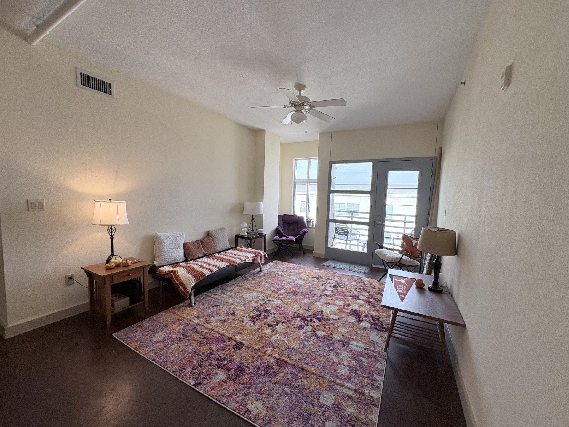 711 West 26th Street, Unit 700 Austin, TX 78705 - Photo 3 of 20 a living room with furniture a large window and a rug