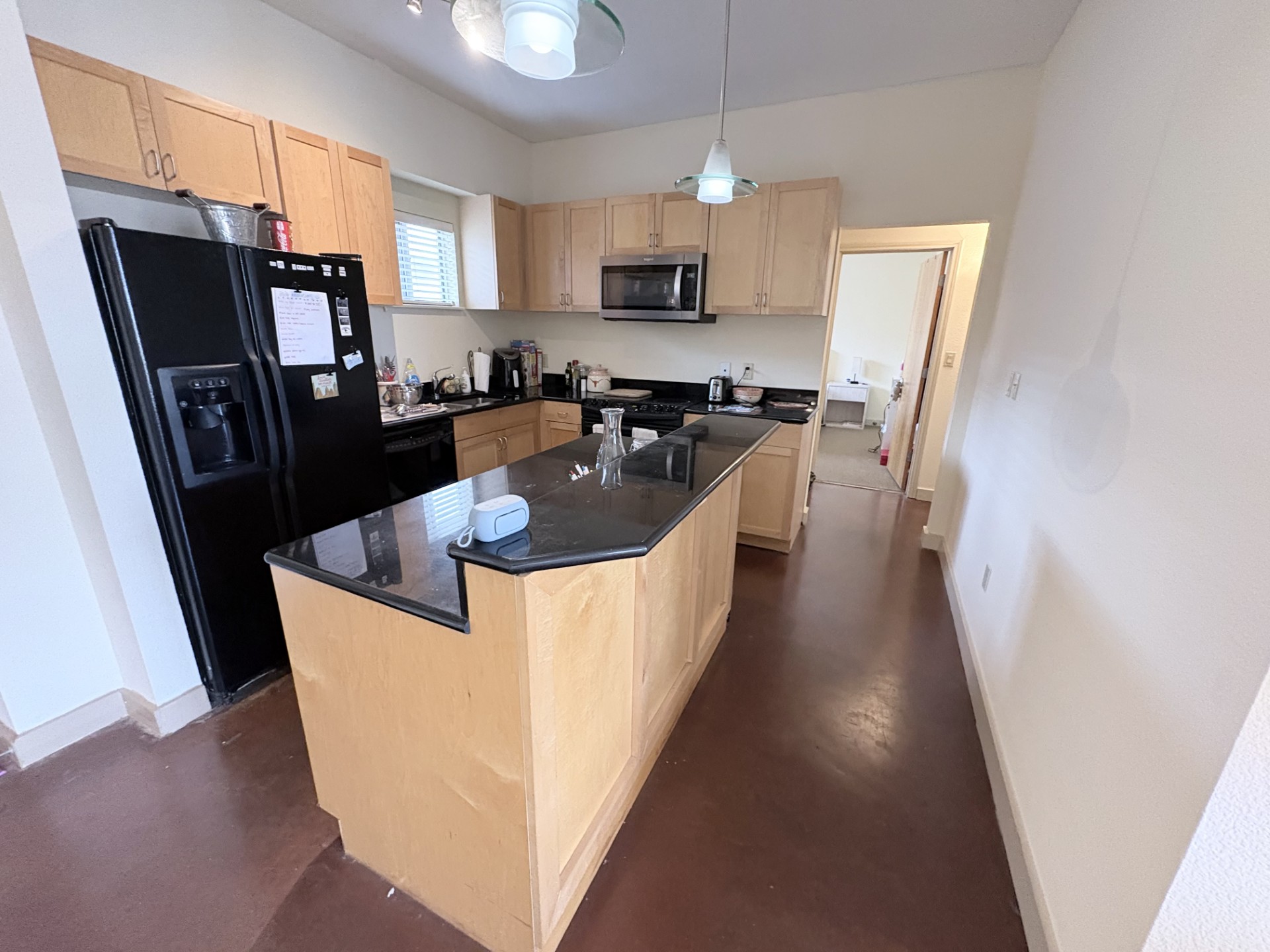 711 West 26th Street, Unit 700 Austin, TX 78705 - Photo 5 of 20 a kitchen with stainless steel appliances granite countertop a refrigerator a sink a stove a washer dryer and a refrigerator