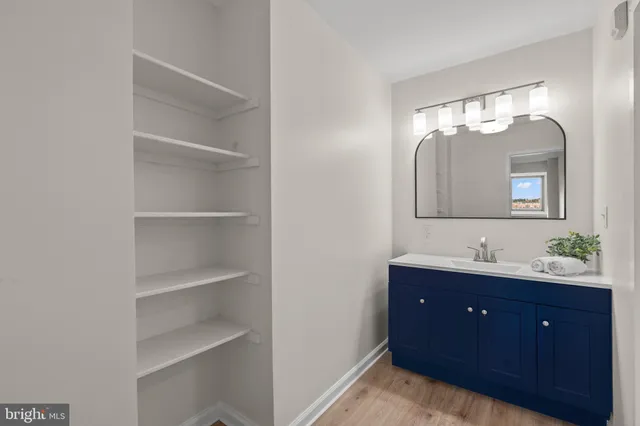 a bathroom with a double vanity sink and a mirror