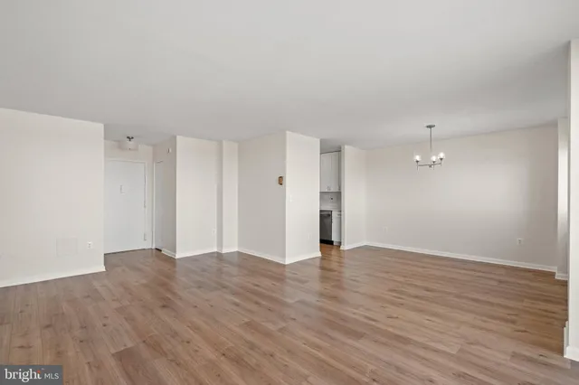 a view of an empty room with wooden floor