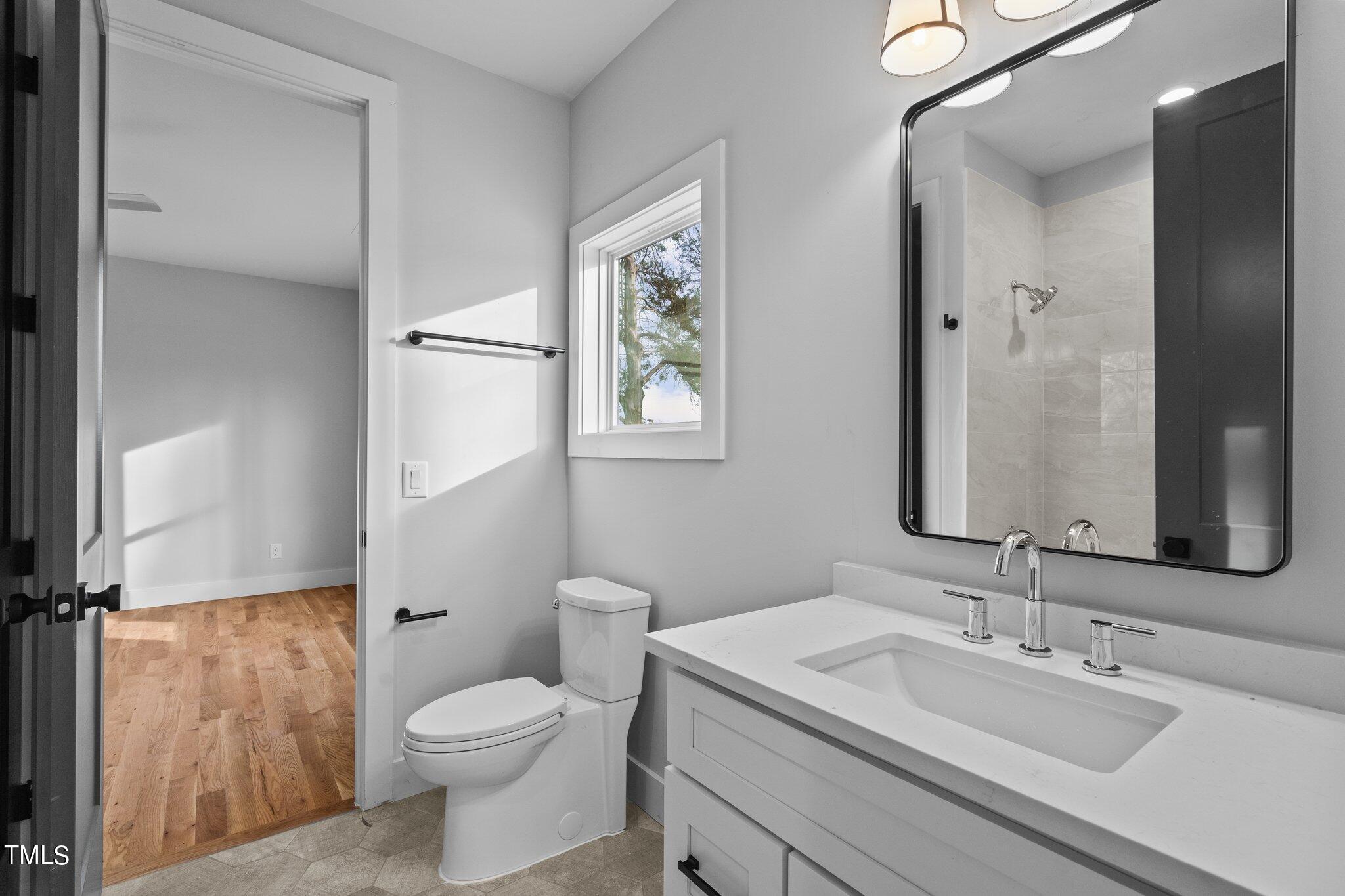 421 Harding Street Raleigh, NC 27604 - Photo 13 of 50 a bathroom with a granite countertop sink toilet and shower