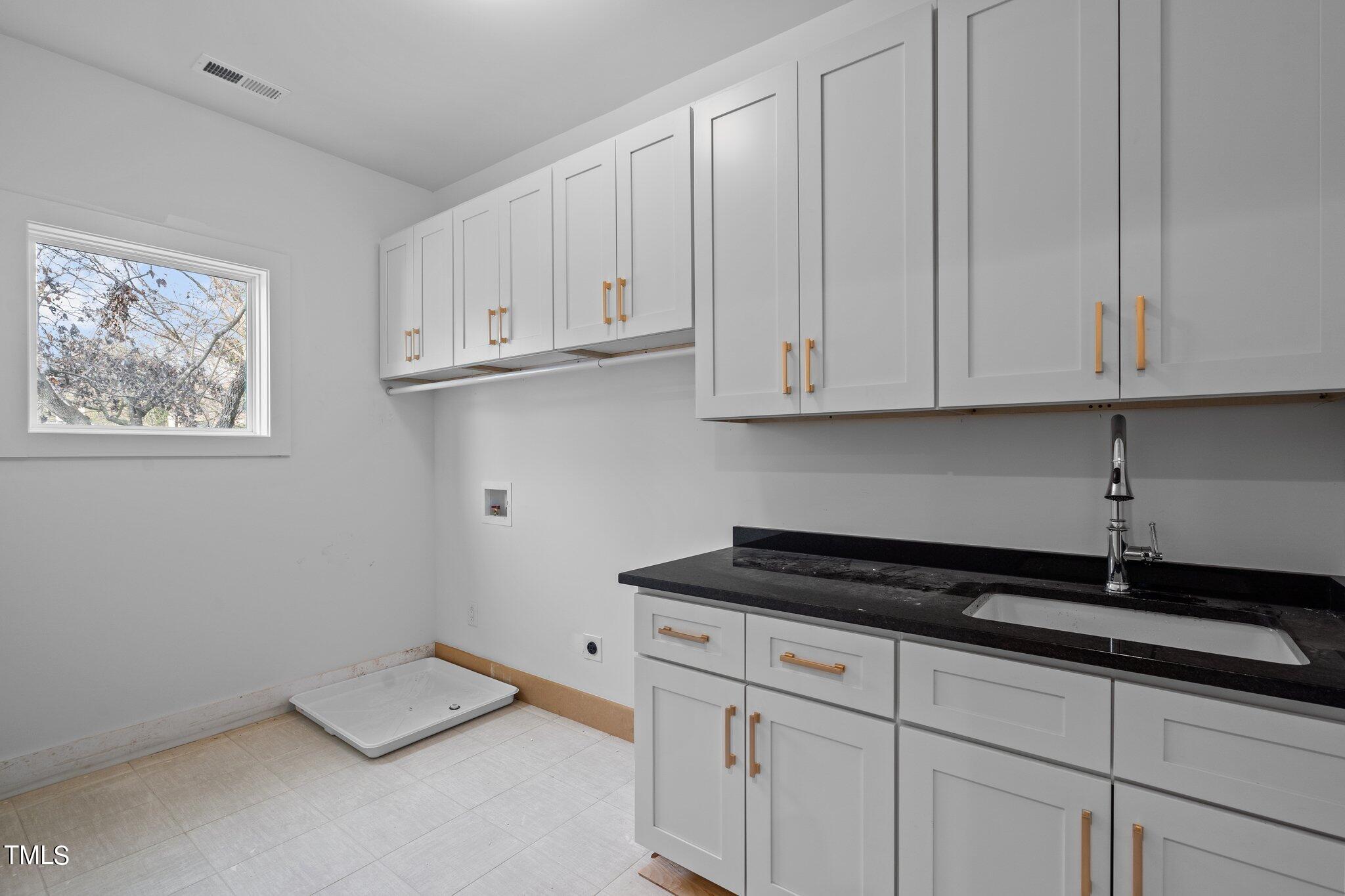 421 Harding Street Raleigh, NC 27604 - Photo 23 of 50 a kitchen with white cabinets and a stove