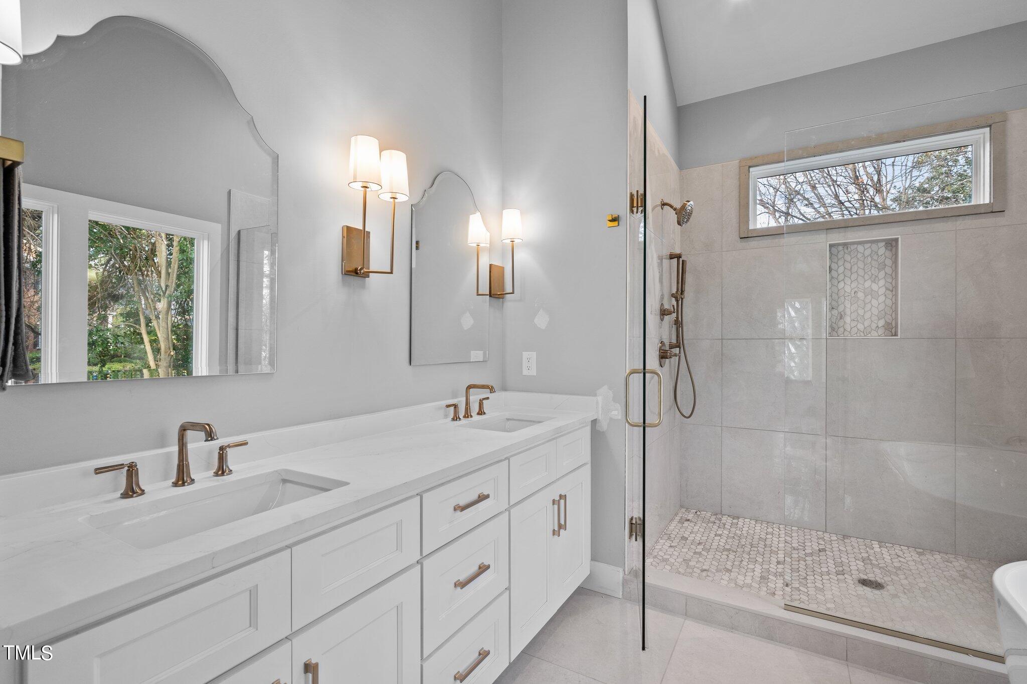 421 Harding Street Raleigh, NC 27604 - Photo 31 of 50 a bathroom with a shower sink and mirror