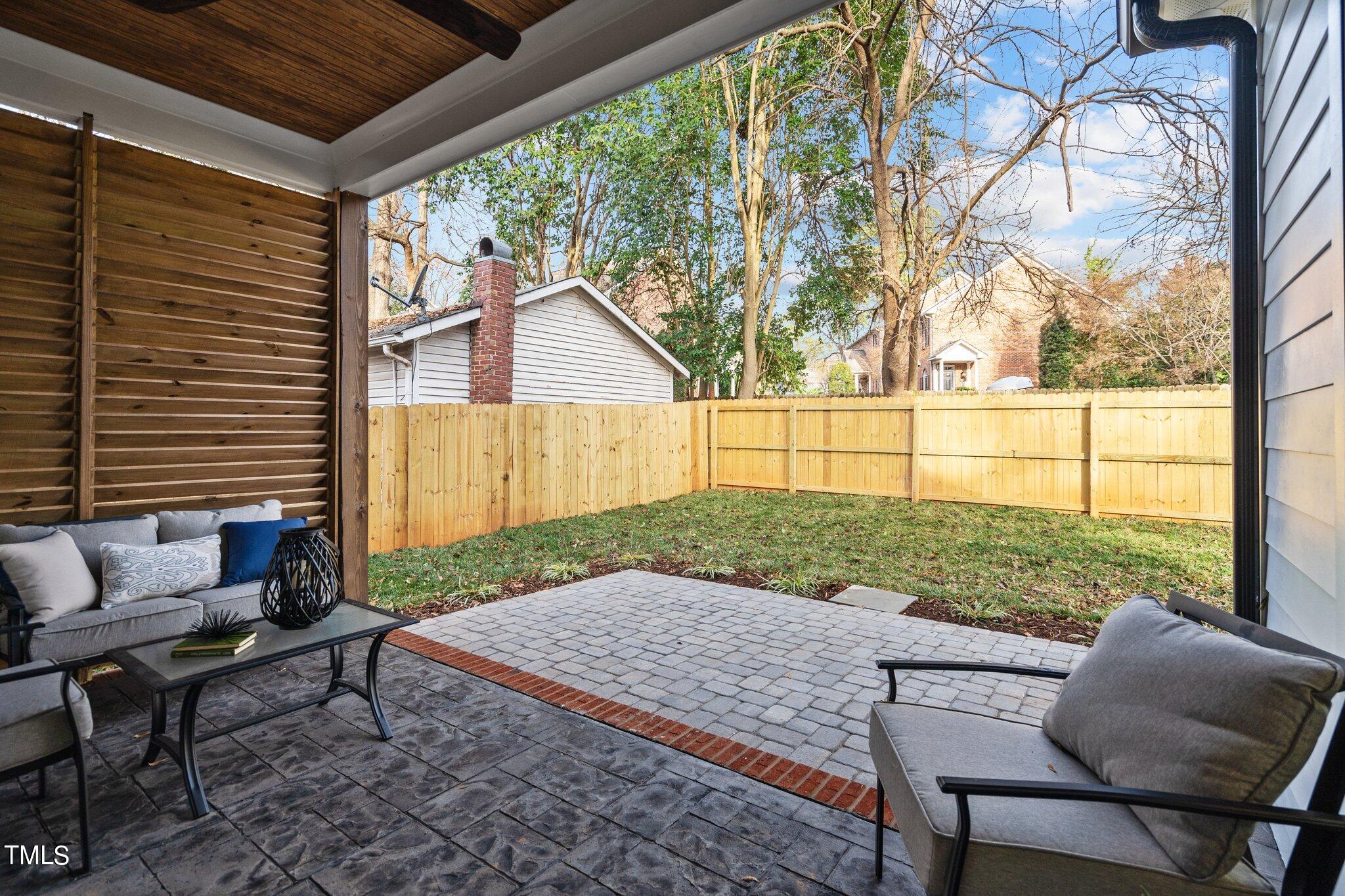 421 Harding Street Raleigh, NC 27604 - Photo 46 of 50 a view of backyard with seating space and wooden fence