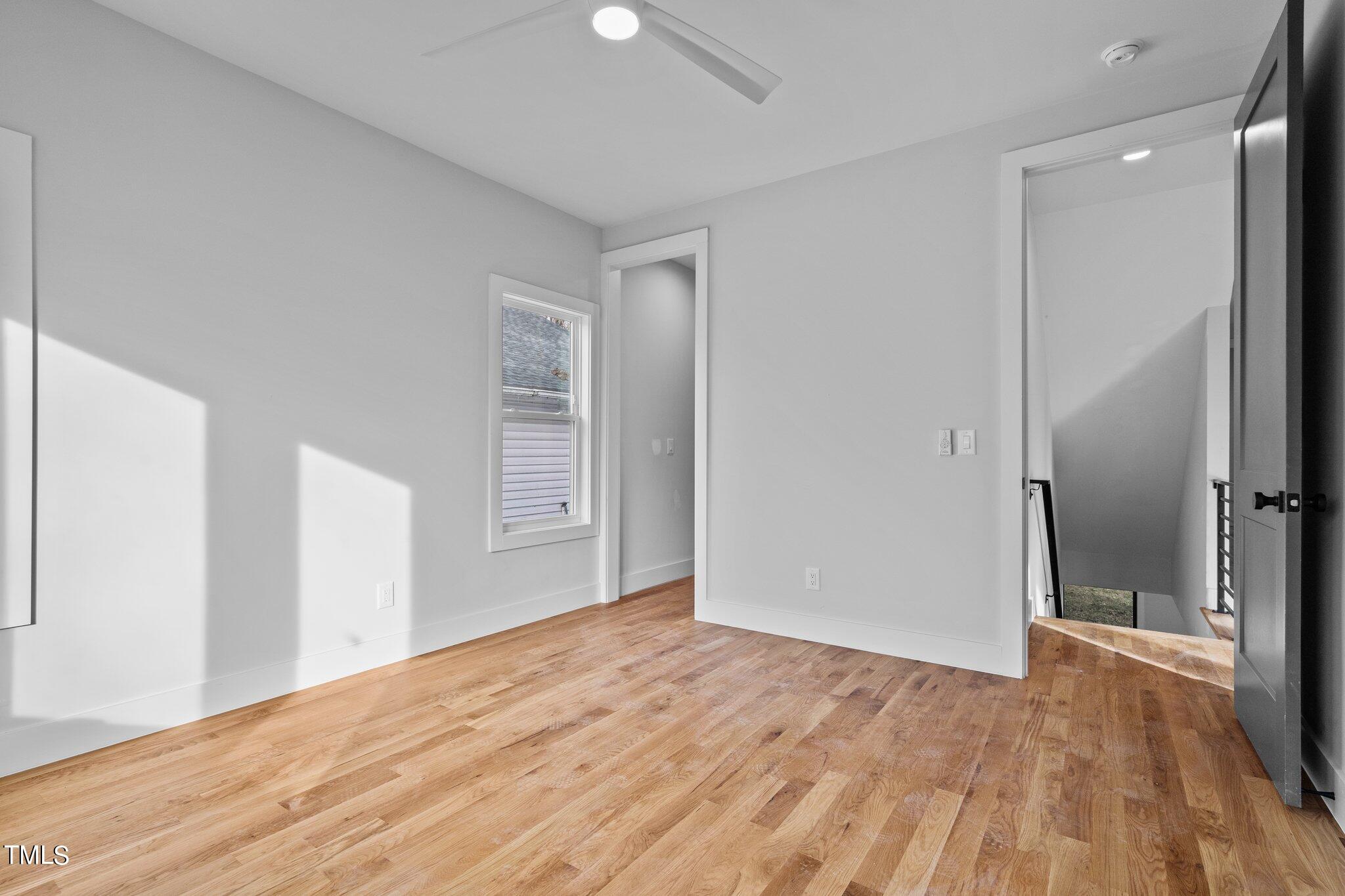421 Harding Street Raleigh, NC 27604 - Photo 8 of 50 an empty room with wooden floor and windows
