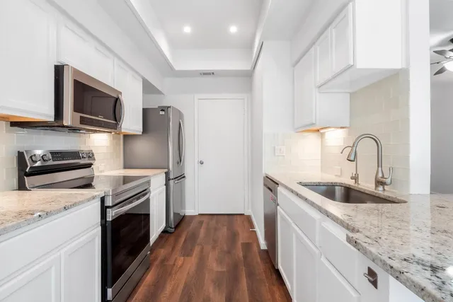 a kitchen with a sink stove and refrigerator