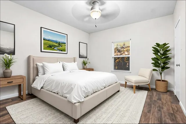 a bedroom with a large bed and a chandelier