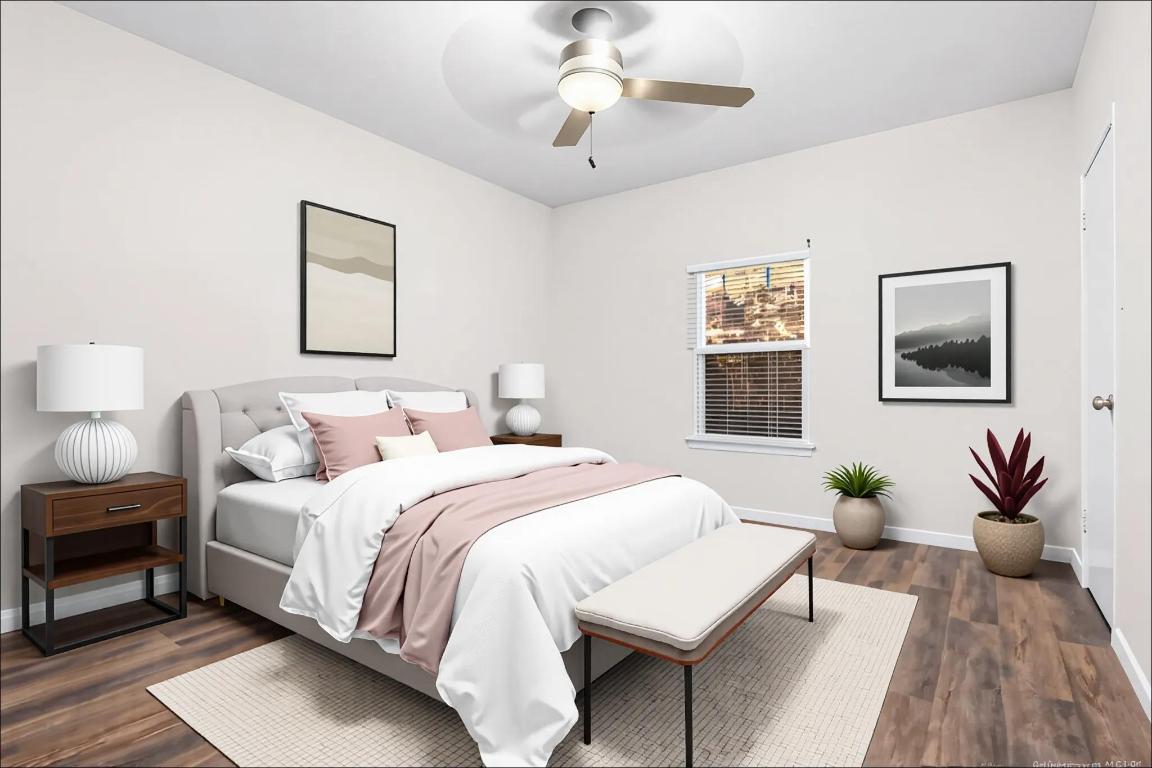 4711 Spicewood Springs Road, Unit 166 Austin, TX 78759 - Photo 15 of 25 a bedroom with a bed a chandelier and a potted plant