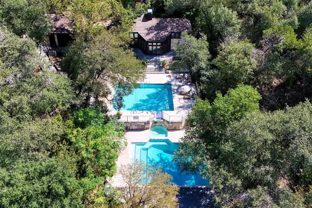 an aerial view of a house with yard swimming pool and outdoor seating
