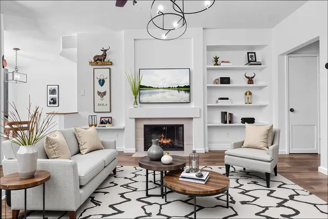 a living room with furniture a rug and a fireplace