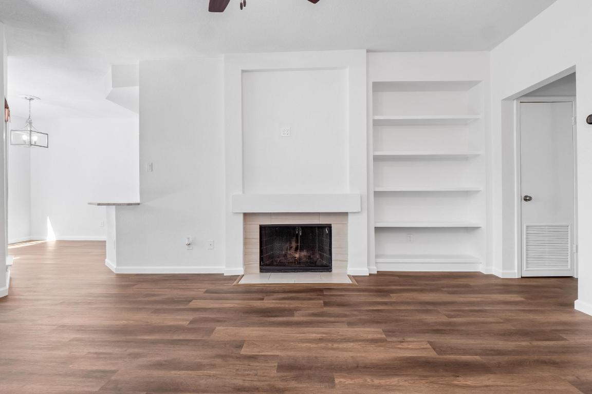 4711 Spicewood Springs Road, Unit 166 Austin, TX 78759 - Photo 6 of 25 a view of a room with wooden floor and a fireplace