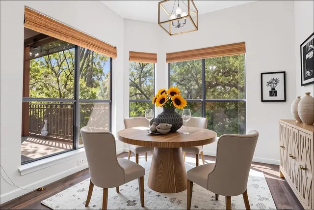 a view of a dining room with furniture large windows and wooden floor