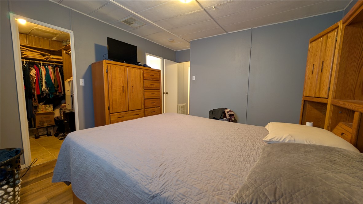 1560 Massachusetts, Unit 96 Riverside, CA 92507 - Photo 12 of 17 a bedroom with a bed and wooden floor