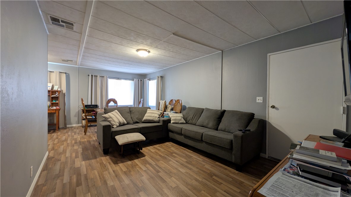 1560 Massachusetts, Unit 96 Riverside, CA 92507 - Photo 16 of 17 a living room with furniture and a wooden floor