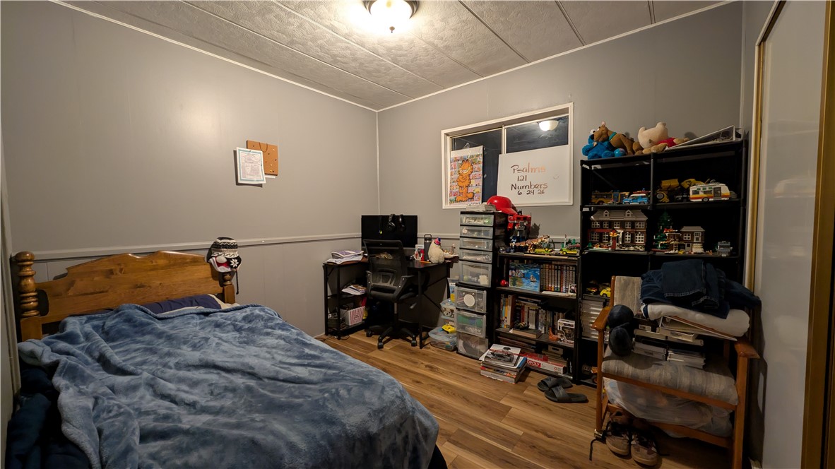 1560 Massachusetts, Unit 96 Riverside, CA 92507 - Photo 10 of 17 a bedroom with a bed and a bookshelf