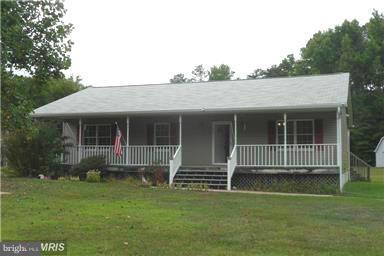 14549 Round Hill Road King George, VA 22485 - Photo 1 of 15 a front view of a house with a garden