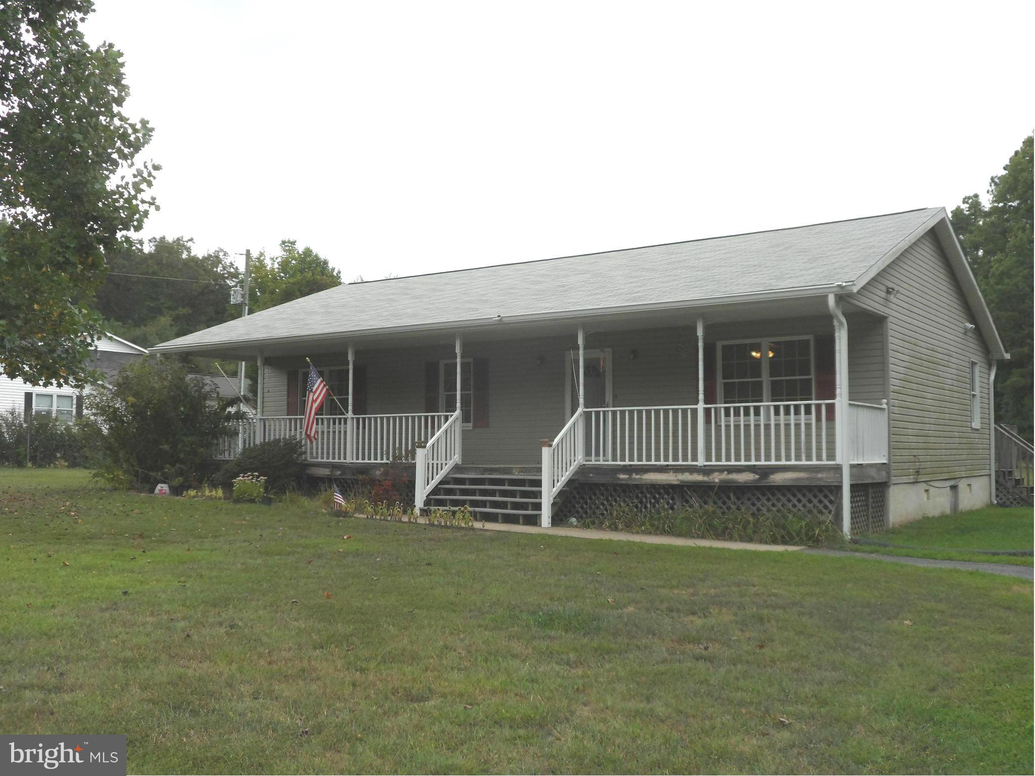 14549 Round Hill Road King George, VA 22485 - Photo 2 of 15 a front view of a house with a garden