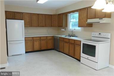 14549 Round Hill Road King George, VA 22485 - Photo 8 of 15 a kitchen with stainless steel appliances a stove a sink and a refrigerator
