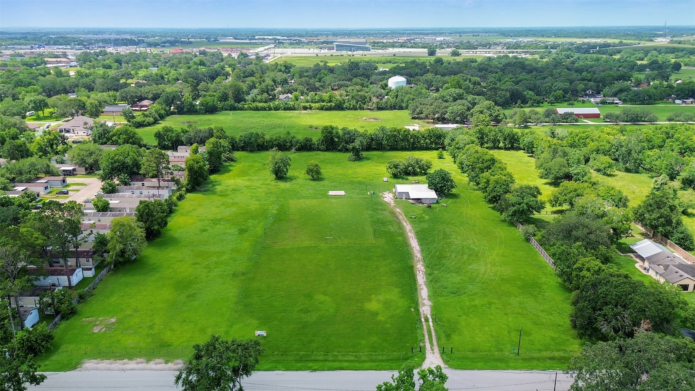 1126 Brooks Avenue Rosenberg, TX 77471 - Photo 9 of 15 a green field with lots of trees in it