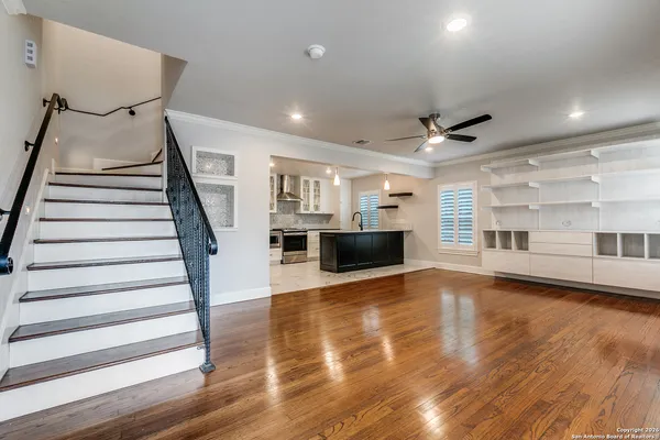 a view of a livingroom with wooden floor and fireplace