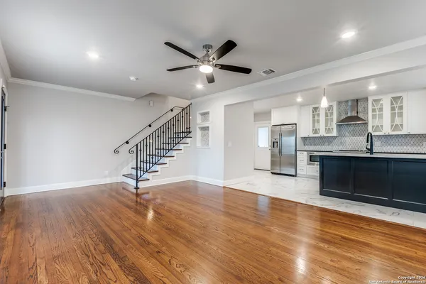 a view of kitchen with sink and wooden floor