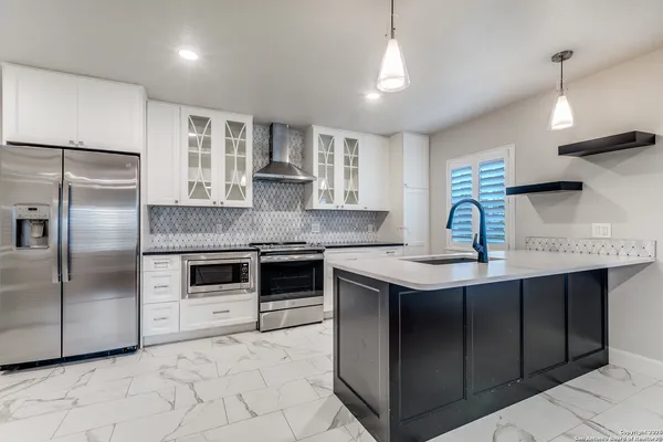 a kitchen with stainless steel appliances granite countertop a sink counter space cabinets and stainless steel appliances