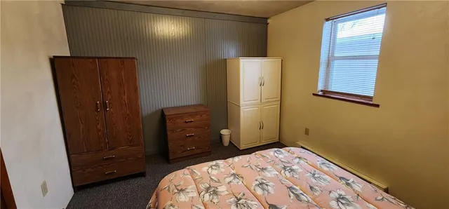 a bedroom with a bed and a dresser