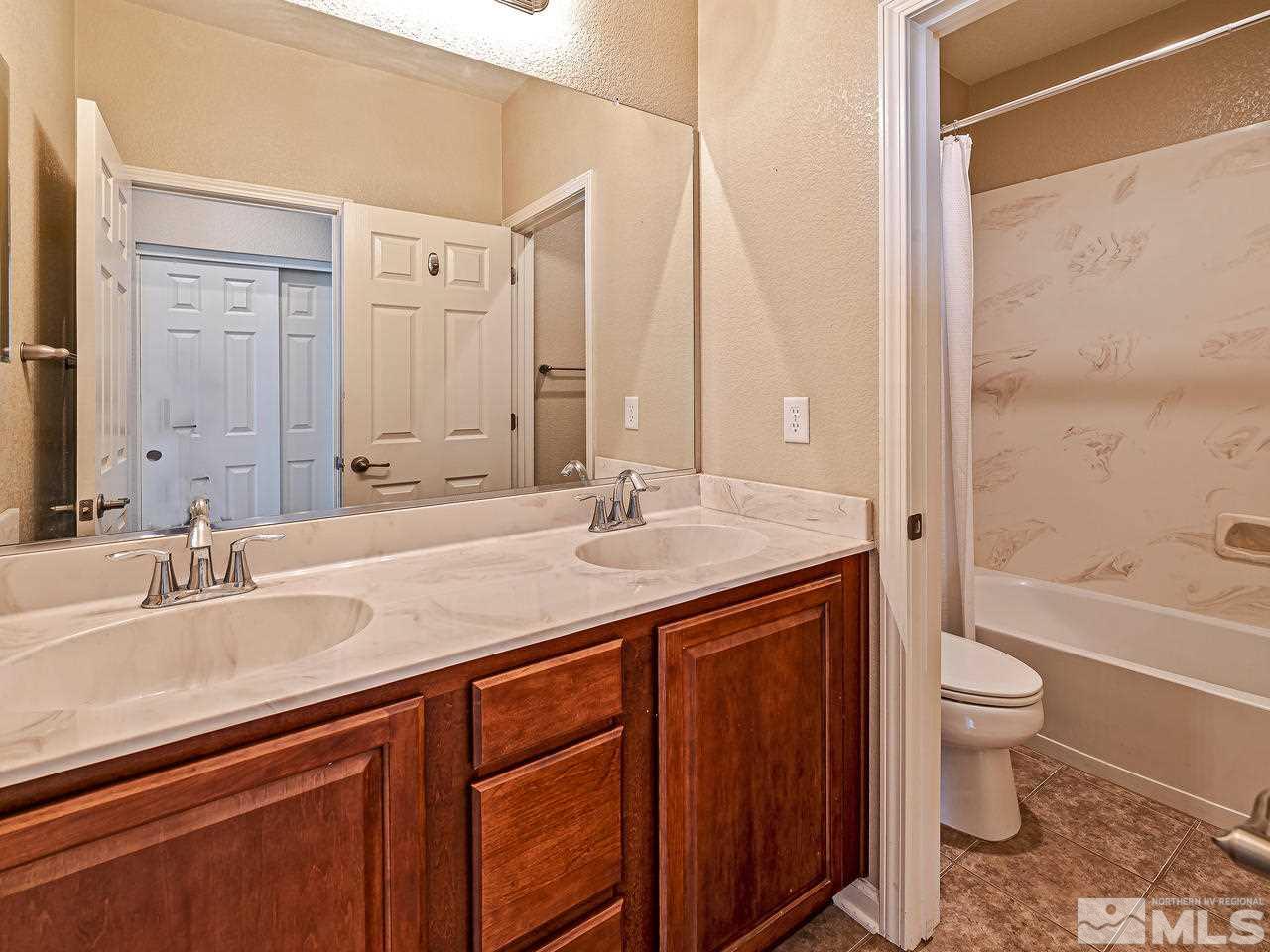 560 Little Sorrel Court Reno, NV 89521 - Photo 13 of 16 a bathroom with a granite countertop sink toilet and shower