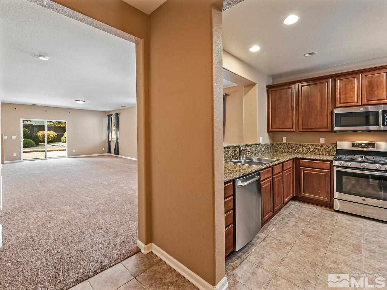 560 Little Sorrel Court Reno, NV 89521 - Photo 3 of 16 a kitchen with a refrigerator stove top oven and sink
