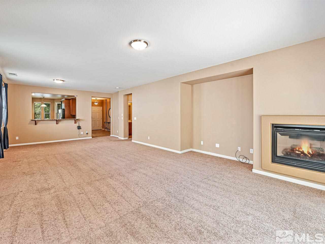 560 Little Sorrel Court Reno, NV 89521 - Photo 8 of 16 a view of an empty room with window and fire place