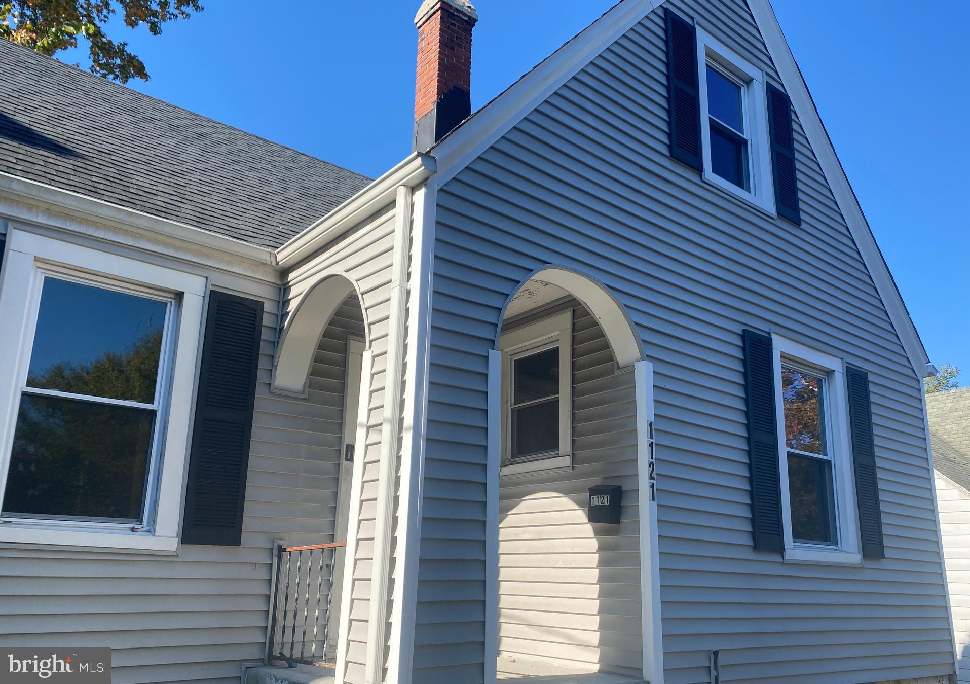 a view of a house with a door and wooden stairs
